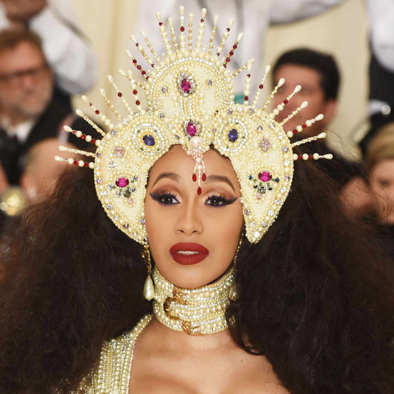 Cardi B wearing a halo crown, her hair in big dramatic waves