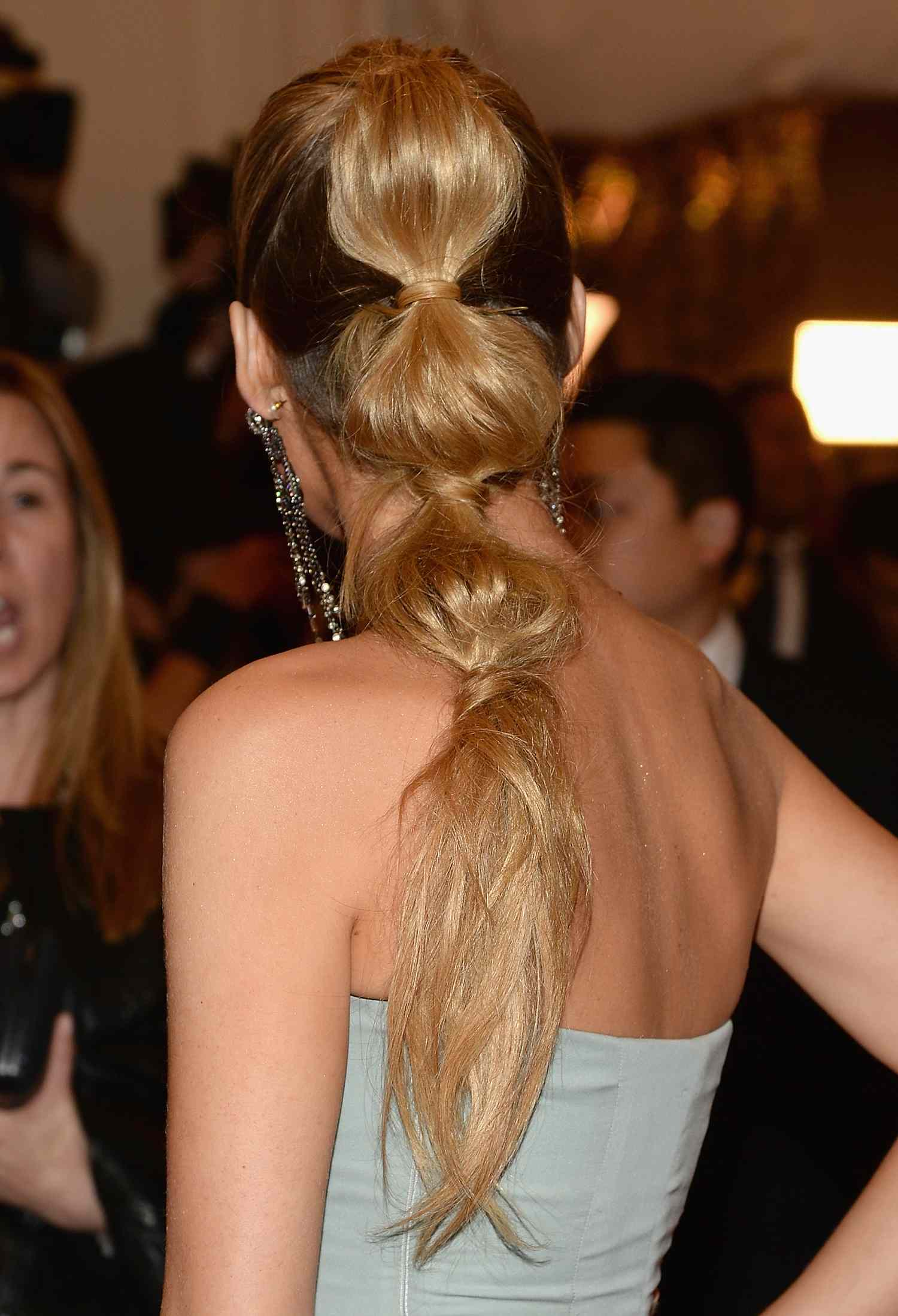 Blake Lively, viewed from behind, her hair in a blonde bubble ponytail