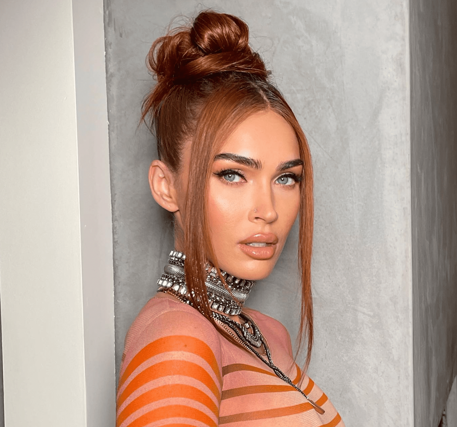 MEGAN FOX IN A SNATCHED TOP KNOT AND STACKED CHOKERS POSING FOR THE CAMERA