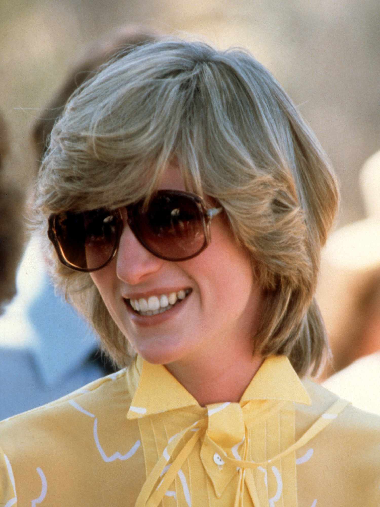 Princess Diana wears a long bob haircut with bangs and face-framing layers