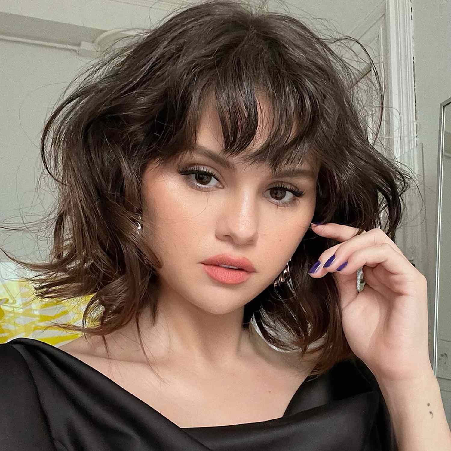 close up of selena gomez with a short, wispy, butterfly bob