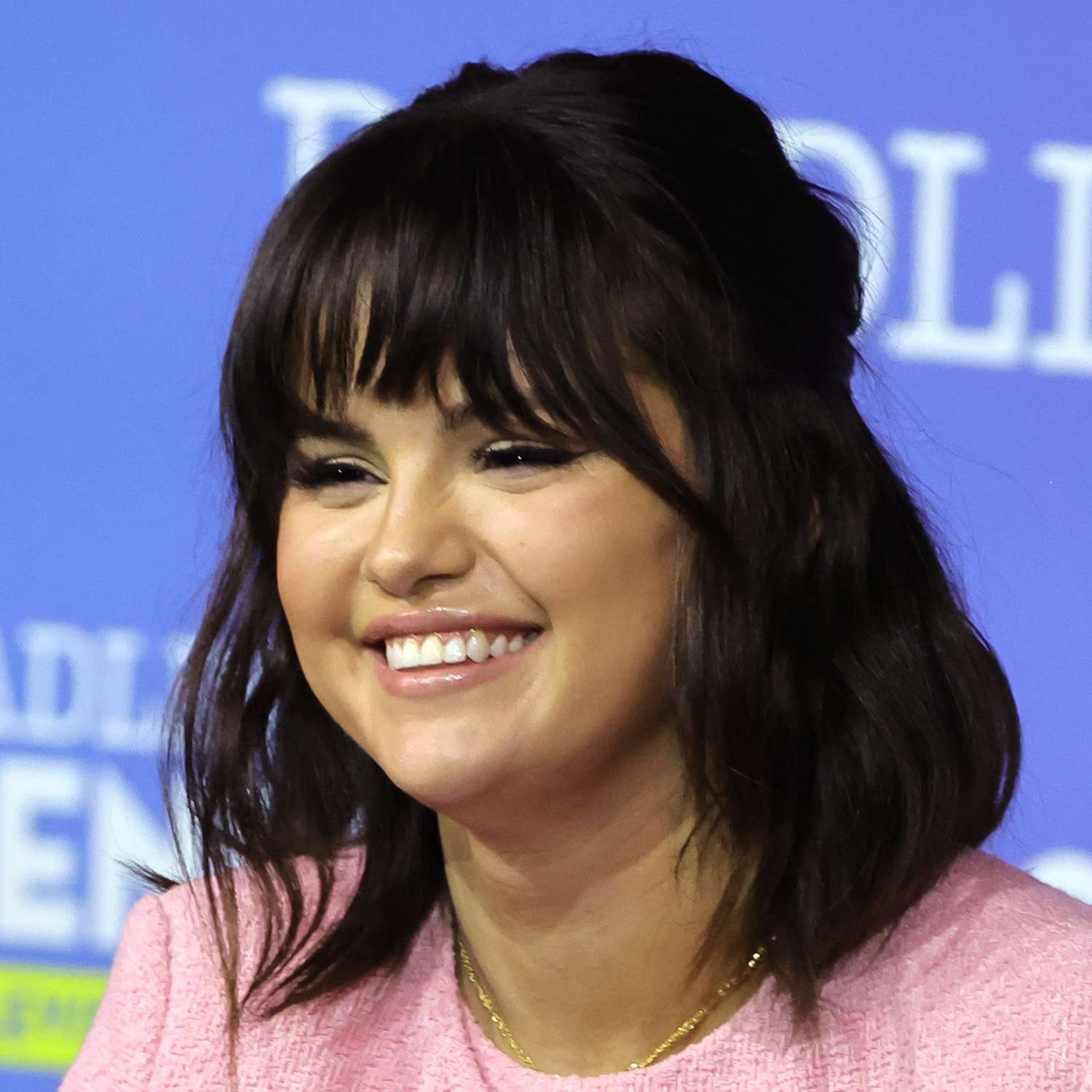 Selena Gomez wears a half-up bob hairstyle with bangs and face-framing layers