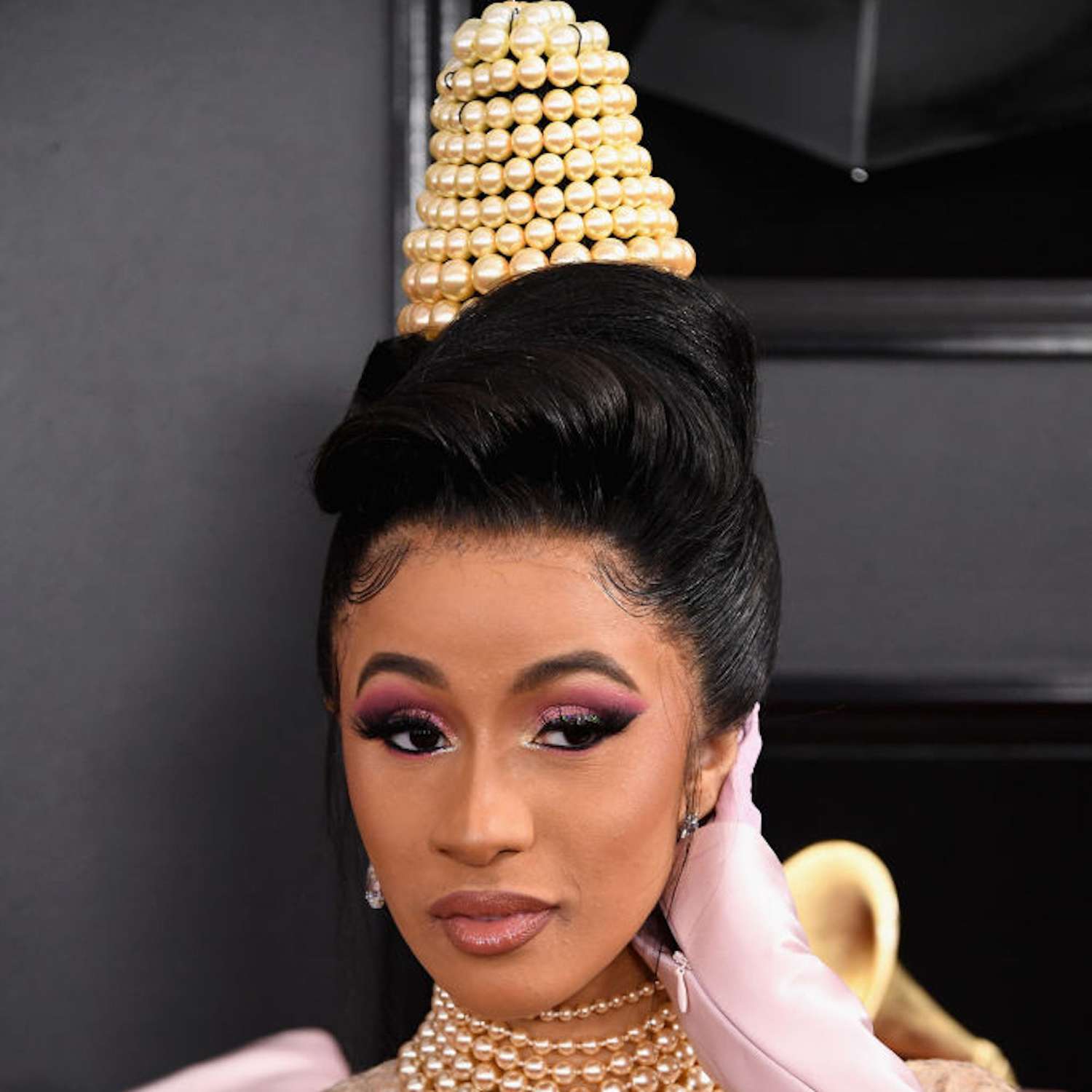 Cardi B with a dramatic updo hairstyle, covered in pears