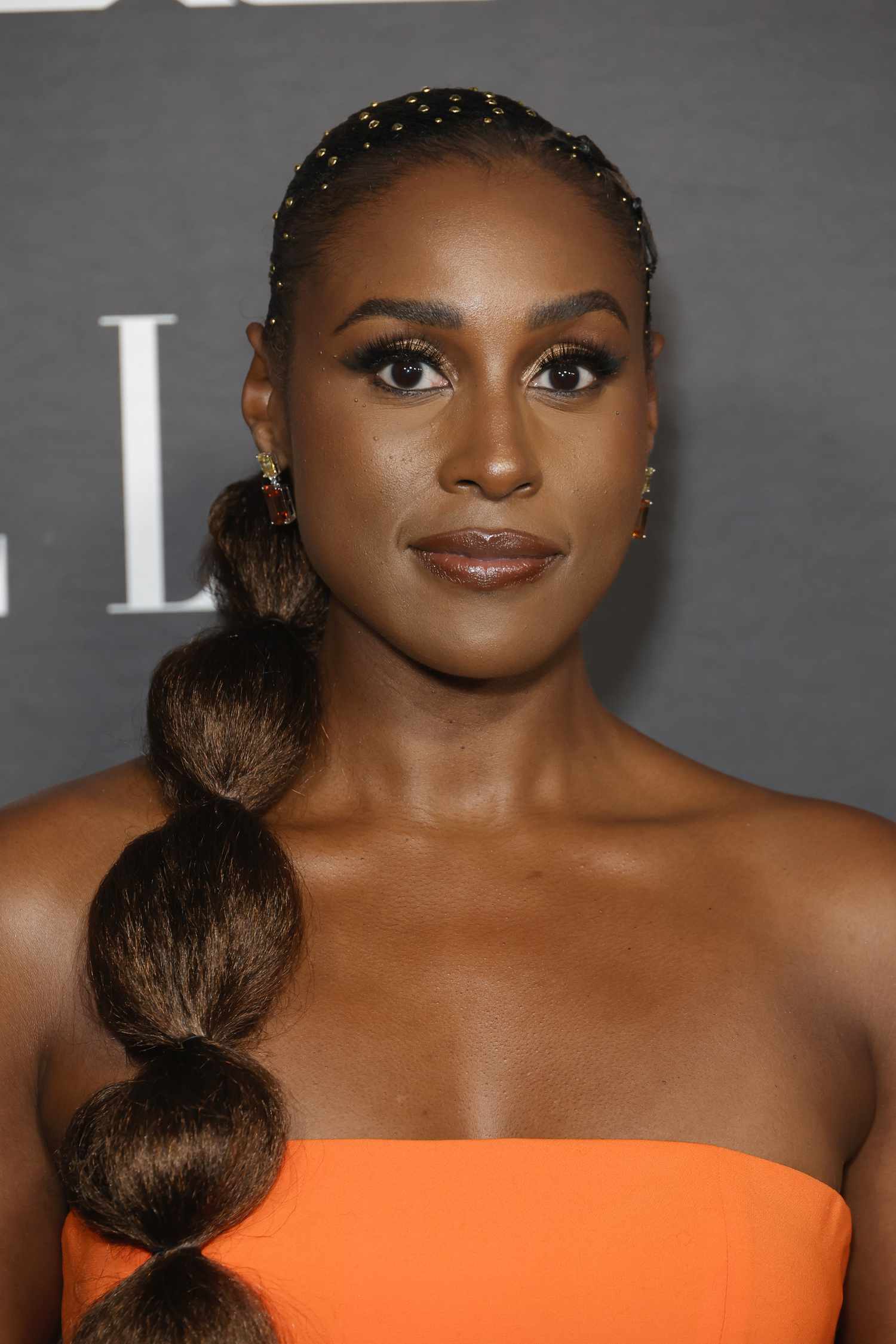 Issa Rae with a long bubble ponytail and hair jewels