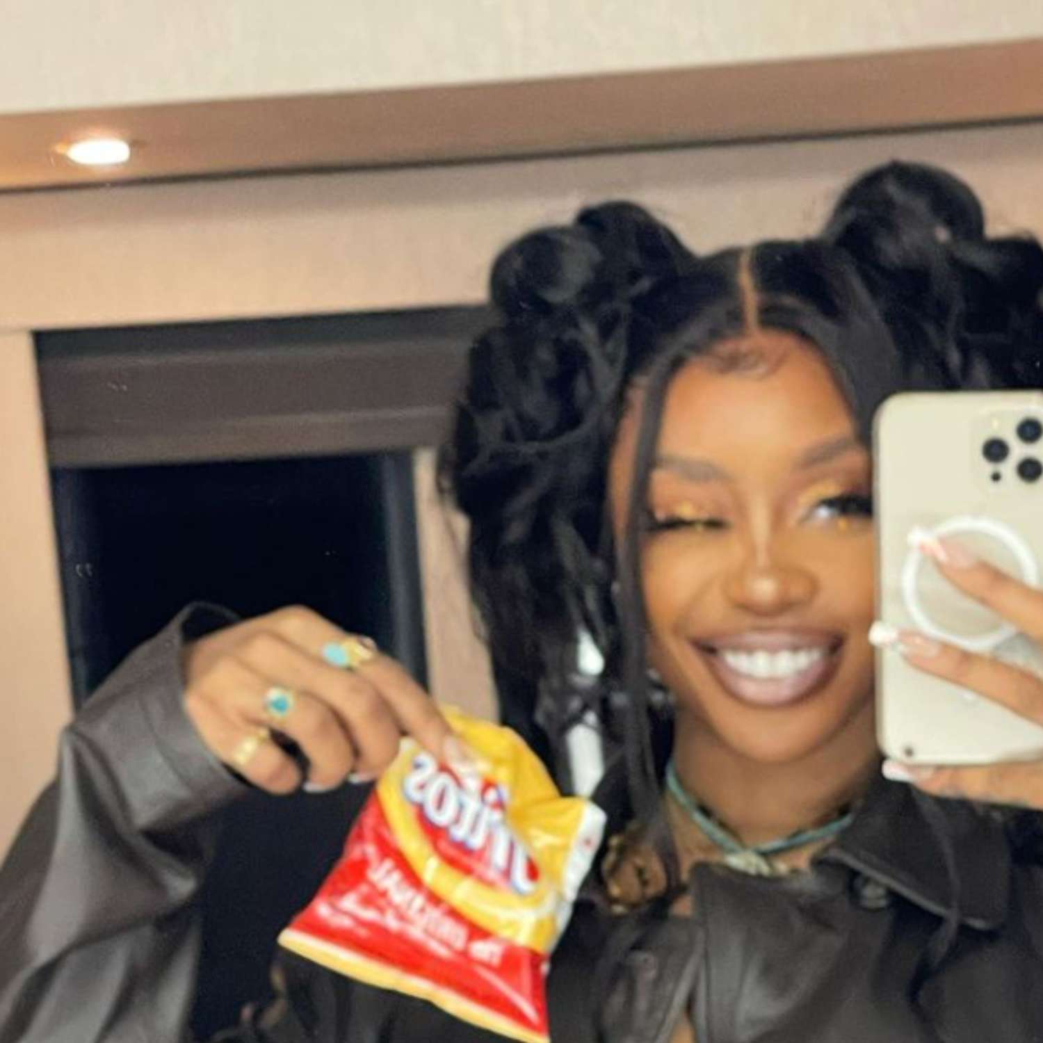 SZA in space-bun pigtails.
