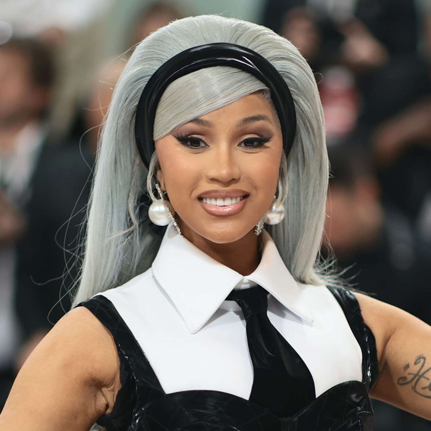 Cardi B with a gray updo and black headband at the Met Gala 2023