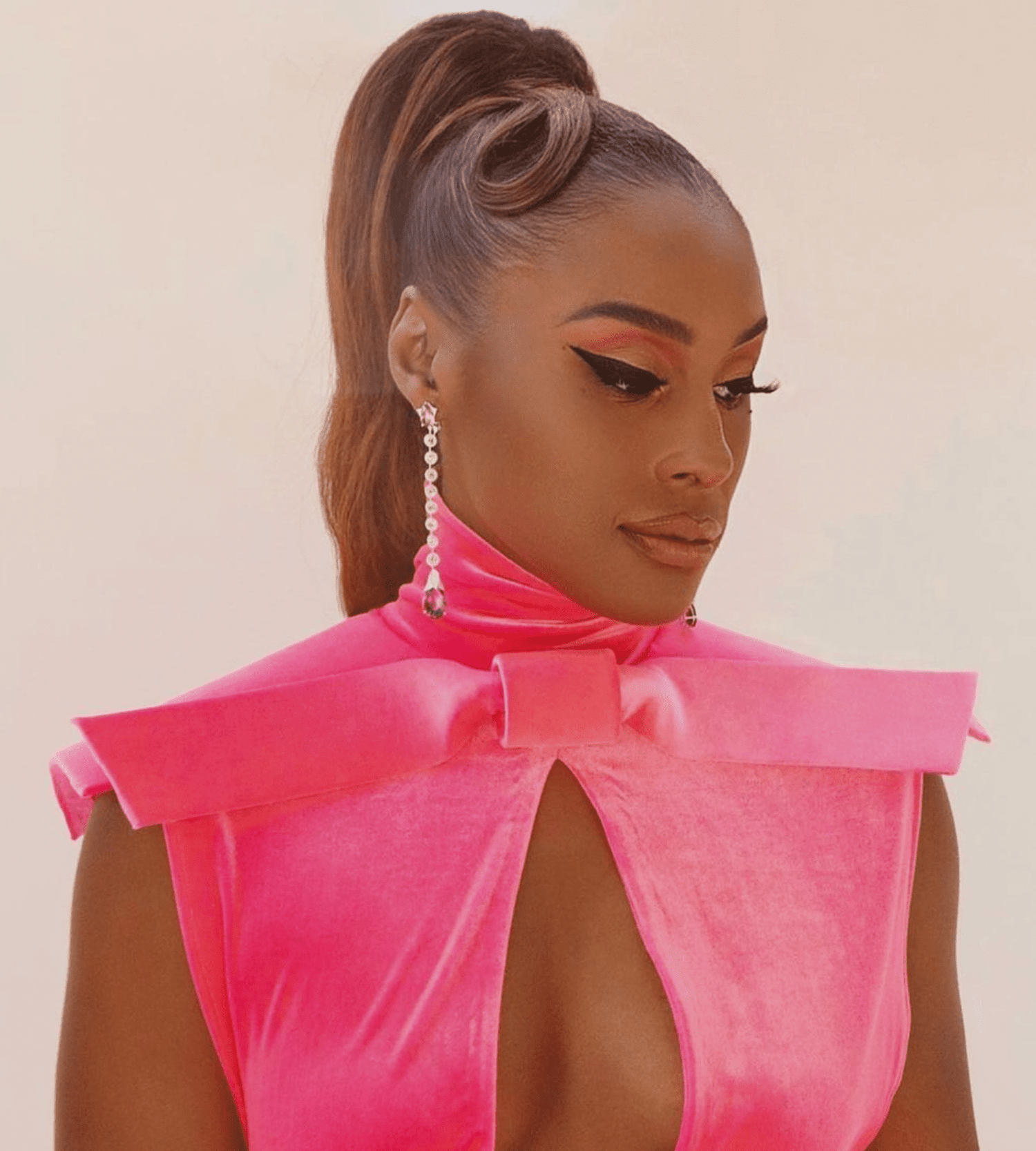 ISSA RAE with a high copper ponytail