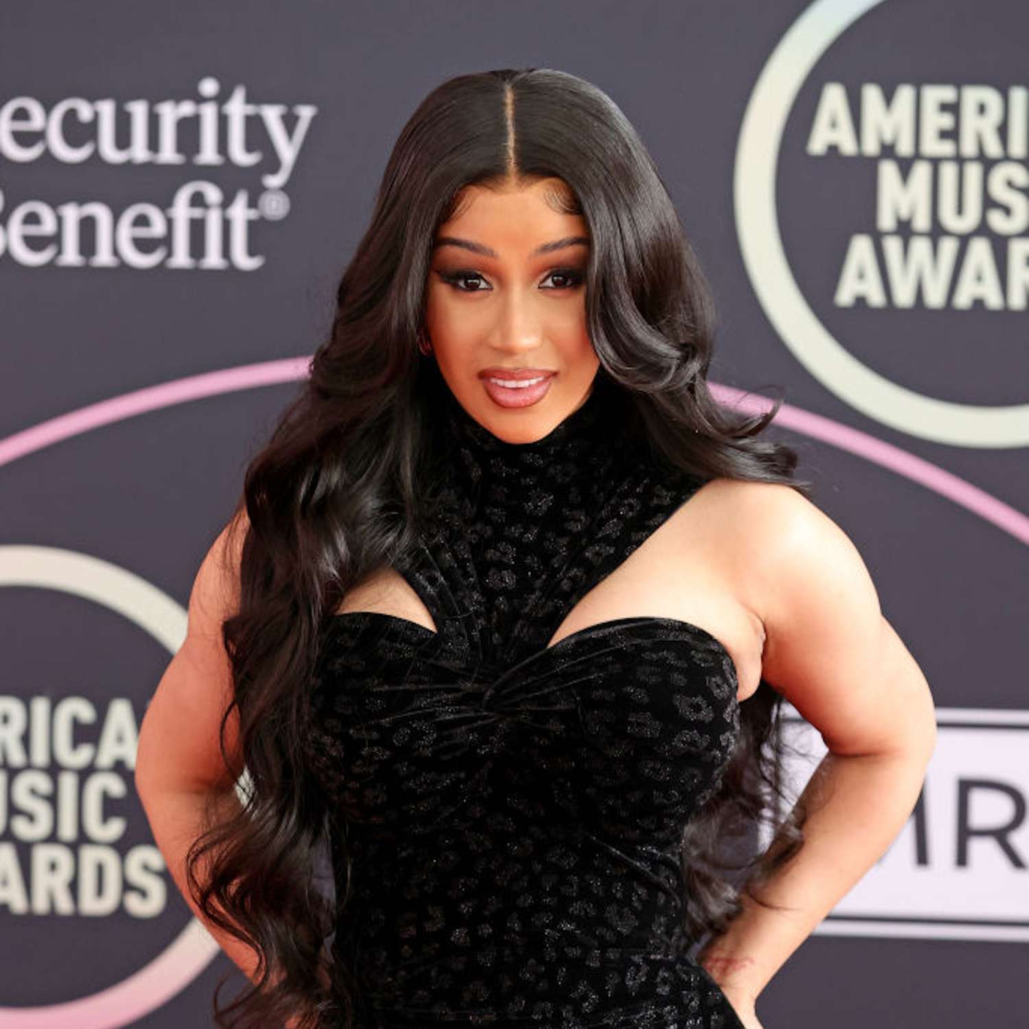Cardi B with center-parted hair with flowing tendrils