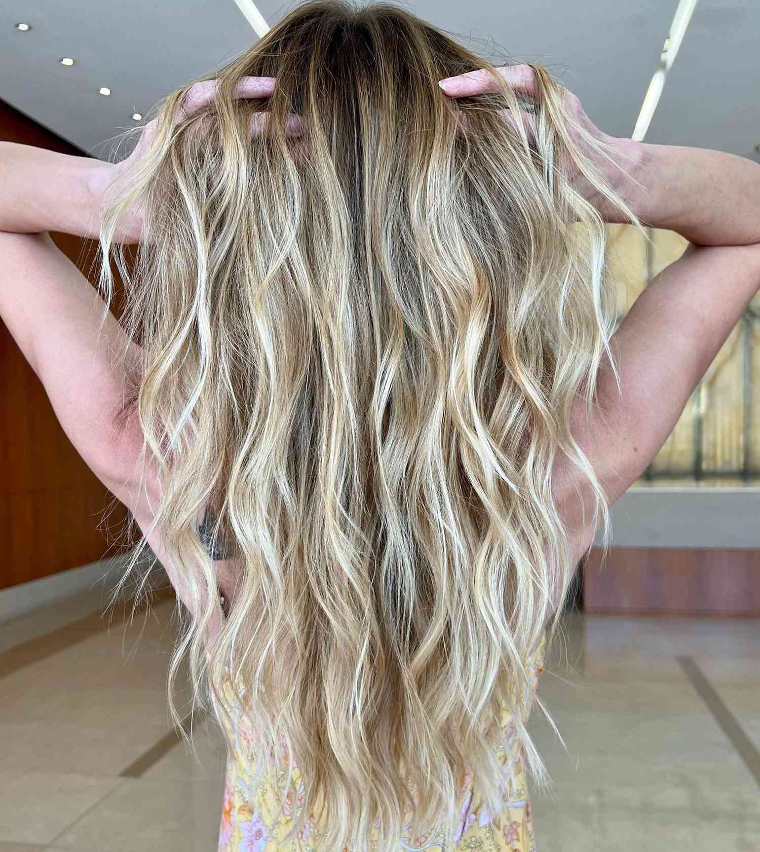 Rear view of wavy blonde hair with teasylights