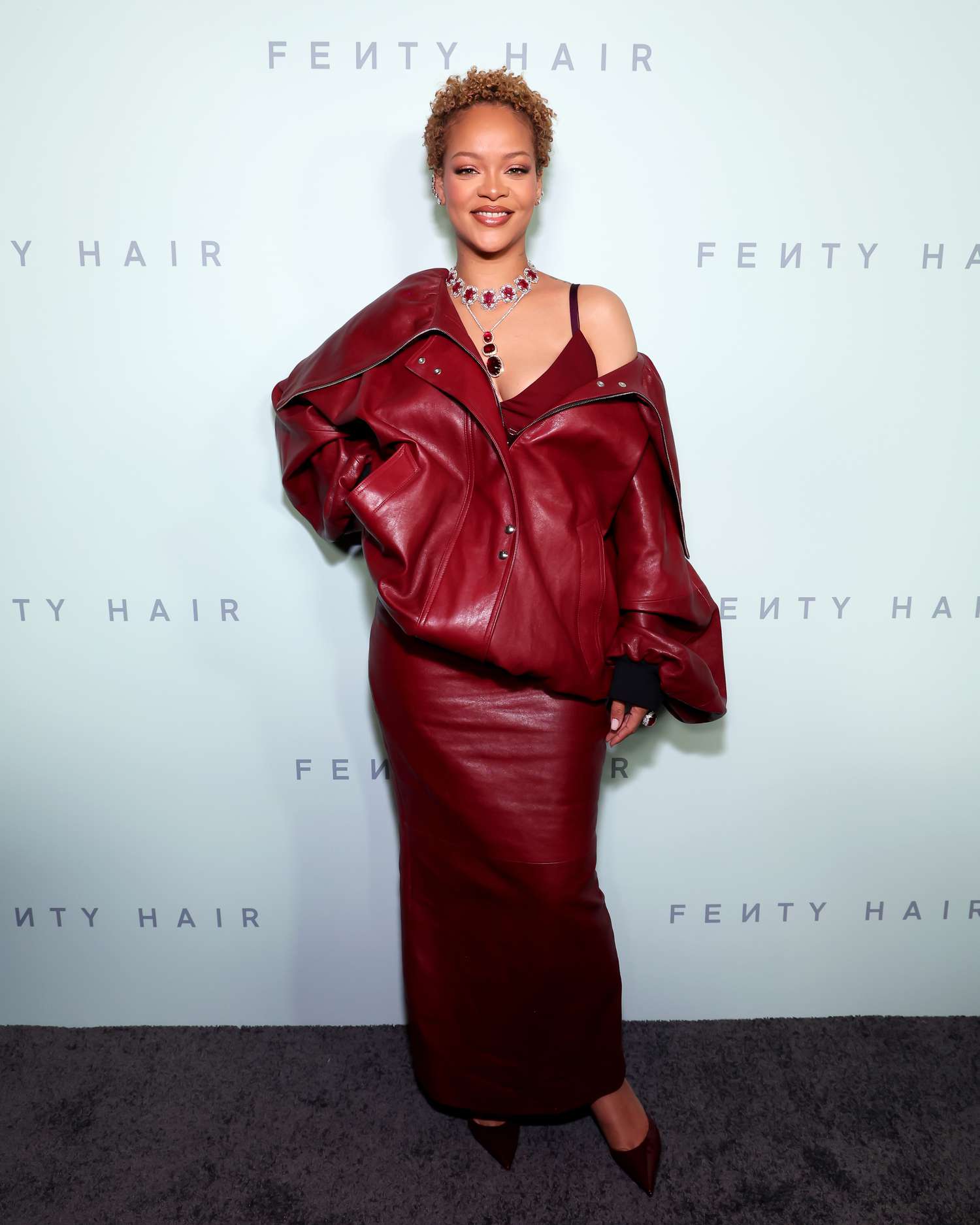 Rihanna wearing her natural curls and a red outfit in Los Angeles.