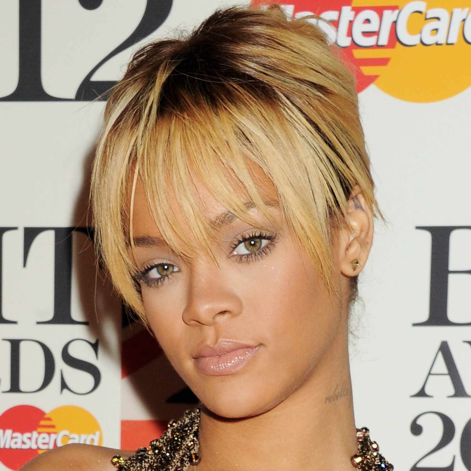 Rihanna wears french bangs on a bleach blonde pixie while in London