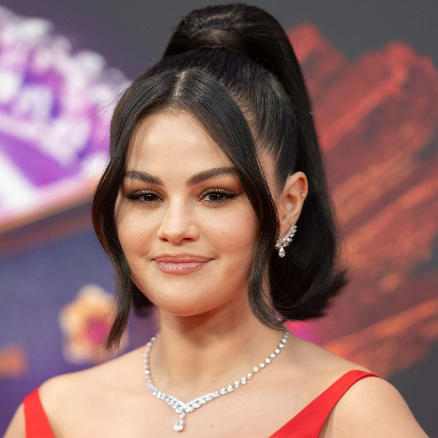 selena gomez with hair pulled back into high ponytail