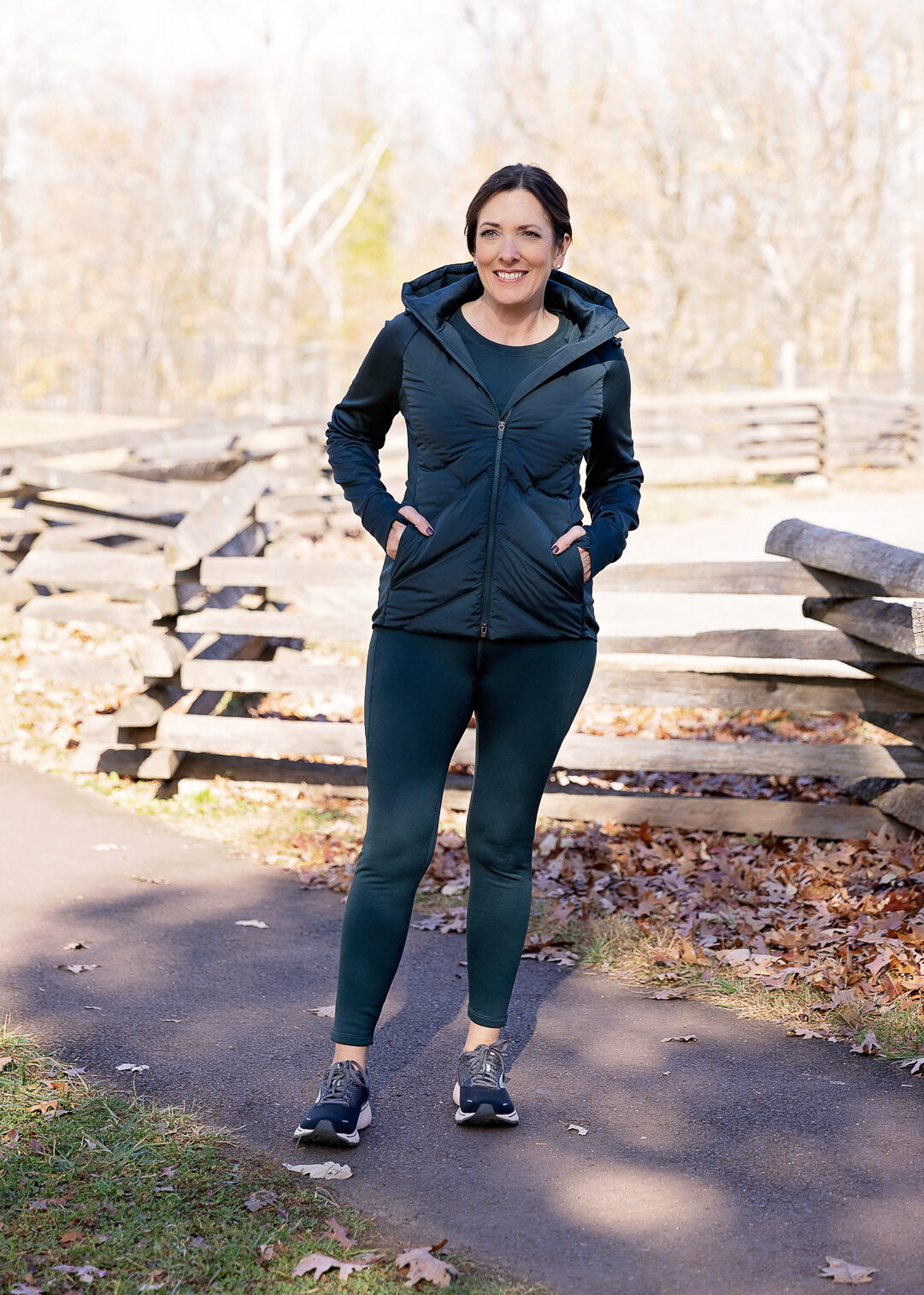 Jo-Lynne Shane wearing the Athleta Altitude Fleece Lined Stash High Rise Leggings with the Athleta Inlet Jacket in Cypress at Valley Forge National Park