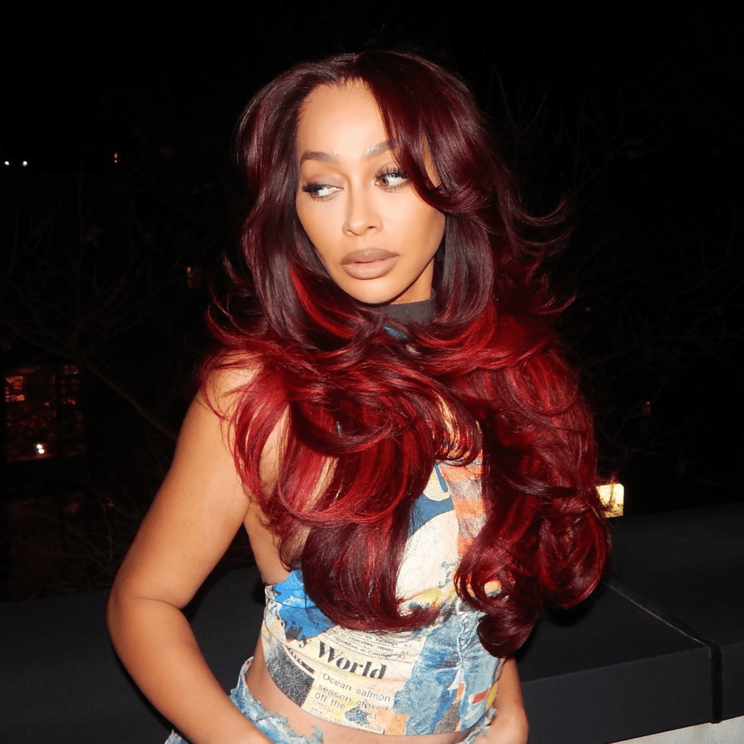 La La Anthony with cola-colored hair that fades into a bright cherry shade at the tips.